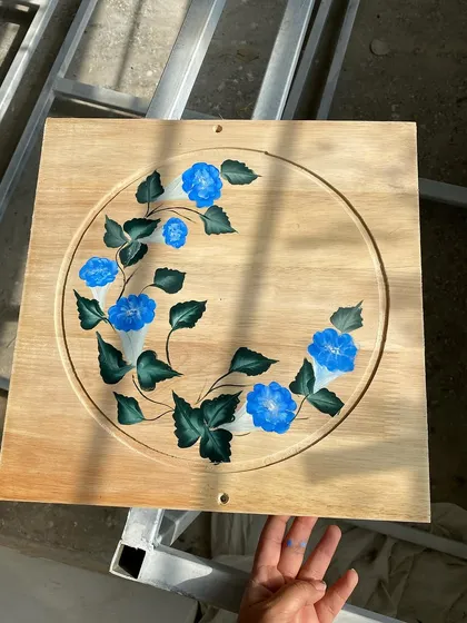 A full view of the morning glory panel, held up to show the finished piece.