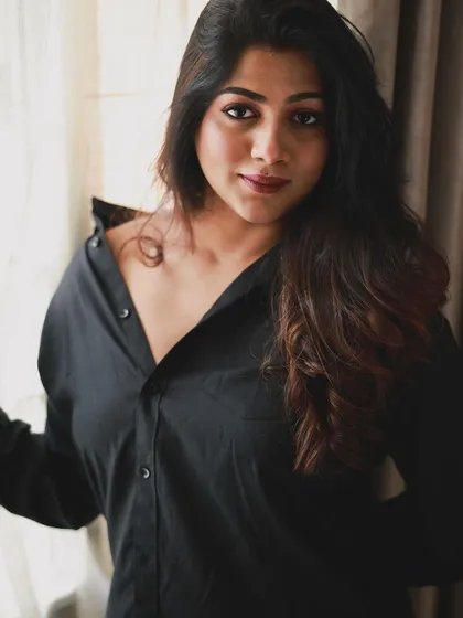 A confident pose that showcases the full effect of the glam look. The hair has volume and the makeup is striking, perfect for making a statement.
