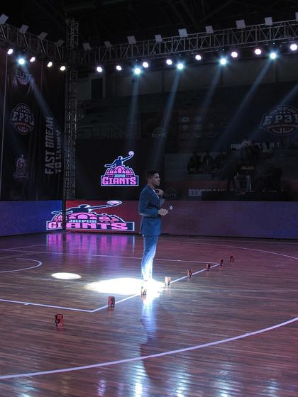 An announcer addresses the crowd during a professional tournament. Our events are managed with a high degree of professionalism, from on-court action to public engagement.