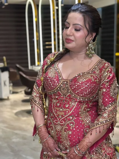 This look showcases a dewy and radiant makeup style on mature skin. I focused on creating a luminous base with soft pink eyeshadow and a matching lip color, enhancing her natural features for a wedding guest look. The braided hairstyle with traditional accessories completes the elegant ensemble.