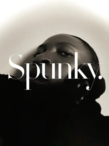 A creative, graphic portrait with a text overlay. The low angle and the model's expression create a bold and confident image, perfect for a magazine-style layout.