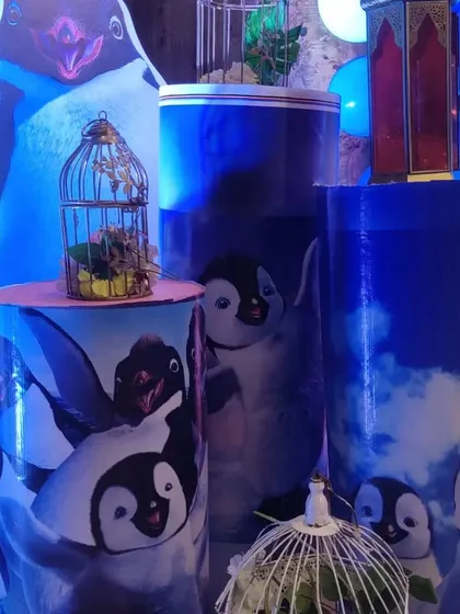 Custom-printed props for a penguin-themed party. These cylindrical stands feature high-quality prints of cartoon penguins, showing how we can tailor props to fit any specific and unique party theme you have in mind.