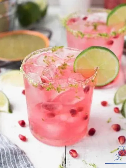 A bright and beautiful pomegranate margarita, garnished with a lime wheel. This drink is a perfect example of how we use fresh, seasonal ingredients to create stunning cocktails.