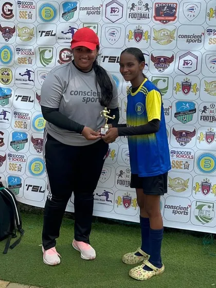 Coach and player celebrating a hard-earned award at their first tournament together.