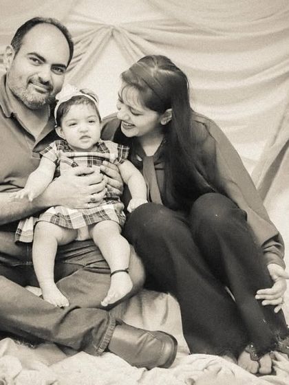 A classic family portrait in a sepia-toned black and white, giving it a warm, vintage, and timeless quality.