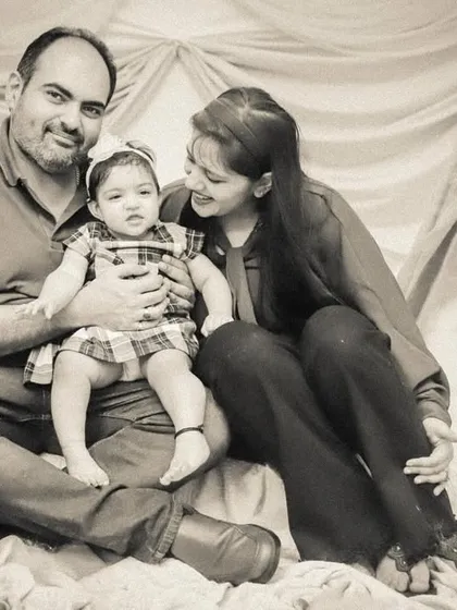 A classic family portrait in a sepia-toned black and white, giving it a warm, vintage, and timeless quality.