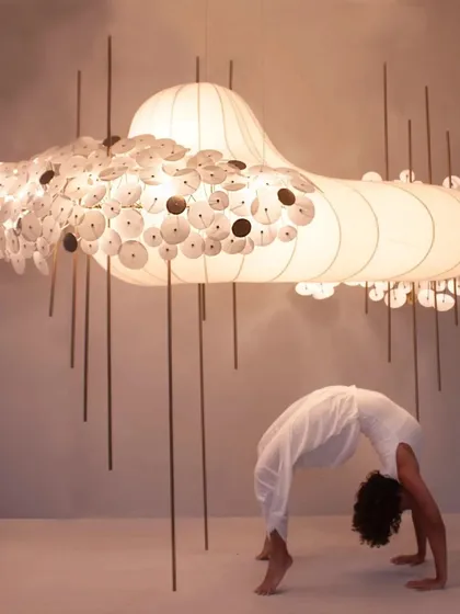 I love exploring movement as a form of art. Here I am in Chakrasana, or Wheel Pose, during a photoshoot. This pose is a deep heart opener, and it felt incredible to practice alongside this beautiful, layered art installation.