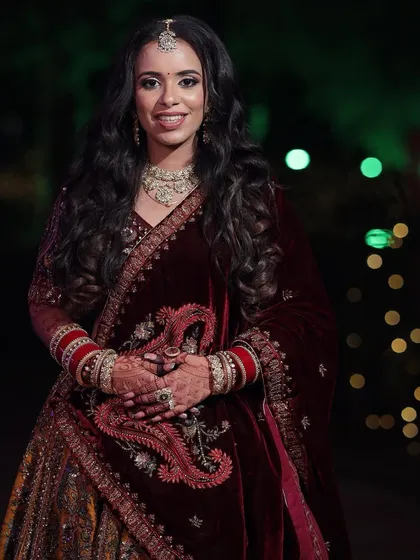 Palak's reception look was all about subtle elegance. Her multi-colored lehenga was paired with a soft makeup look and beautiful open waves.