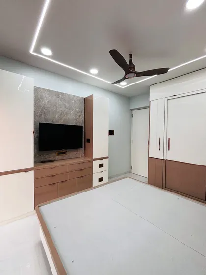 A complete bedroom furniture layout, including a bed with storage, a sliding wardrobe, and a multi-drawer TV unit, all in a cohesive white and wood-grain finish.