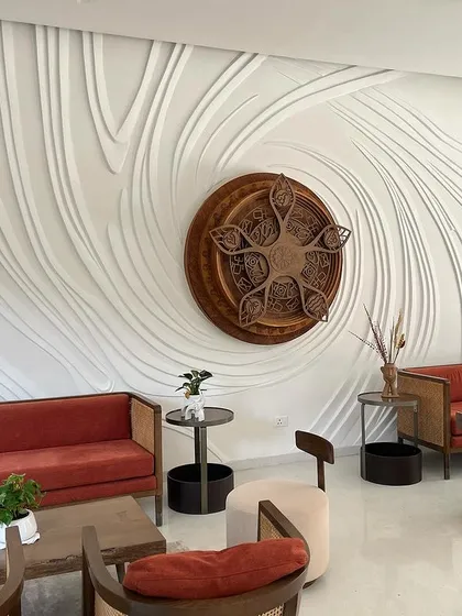 This is what we mean when we say walls have stories. We sculpted this large scale relief mural directly onto the wall, creating a flowing, textured surface that interacts with the room's light and shadows throughout the day.
