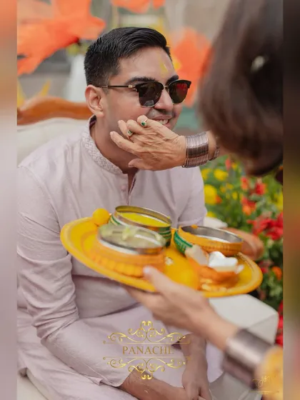 A close-up of the Haldi being applied to the groom, a moment of tradition and blessing.