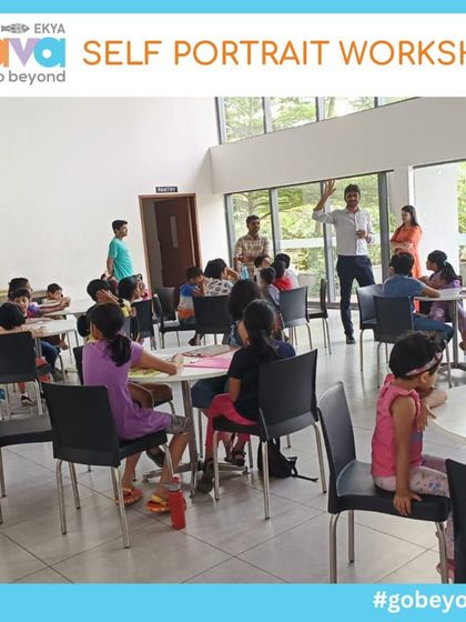 A wide shot of the Self-Portrait Workshop in progress, with families gathered at tables, fully engaged in their art. This image captures the collaborative and lively atmosphere of my weekend events.