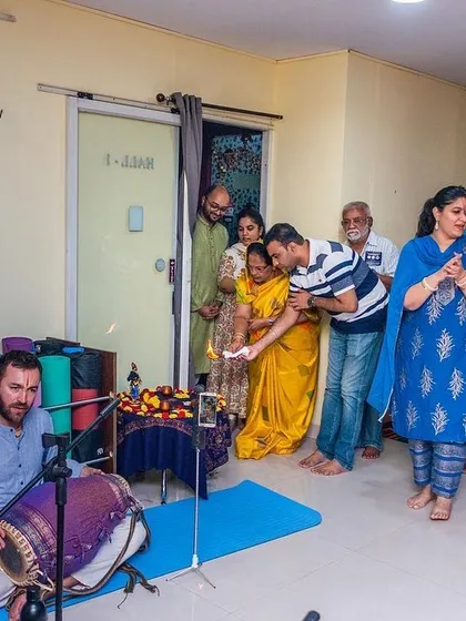 Participants receiving blessings and prasadam at the conclusion of a devotional gathering, a traditional end to our spiritual events.