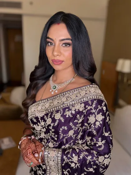 A direct and confident portrait. The makeup is perfectly balanced, with a soft smokey eye and a muted pink lip that enhances her natural beauty.
