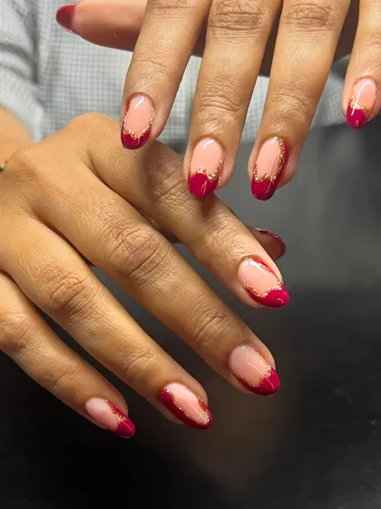 An elegant and modern French design with a deep red tip and a delicate gold glitter line.