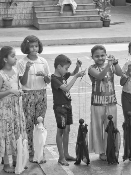 A group of children from our summer camp proudly stand with the marionettes they created. Learning to stand together and present their work is part of the final performance.