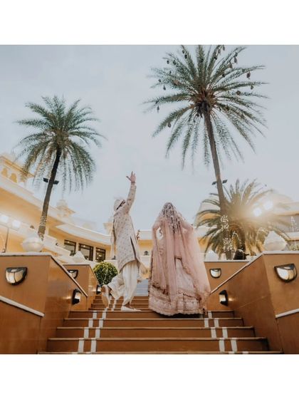 The couple walking up a grand staircase, a symbolic image of their journey ahead together.