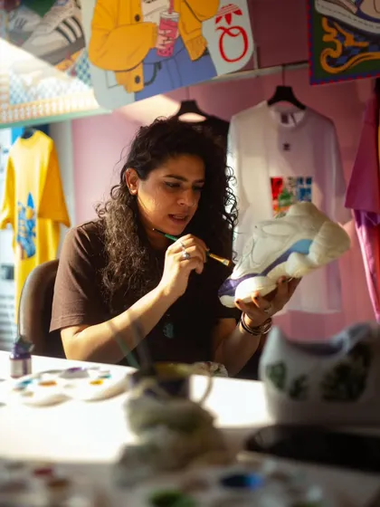 This is me in my element, doing what I love. As a self-taught artist and a one-woman army, my studio is where the magic happens. It’s not always glamorous, but the passion for creating unique, hand-painted sneakers is what drives me every single day.