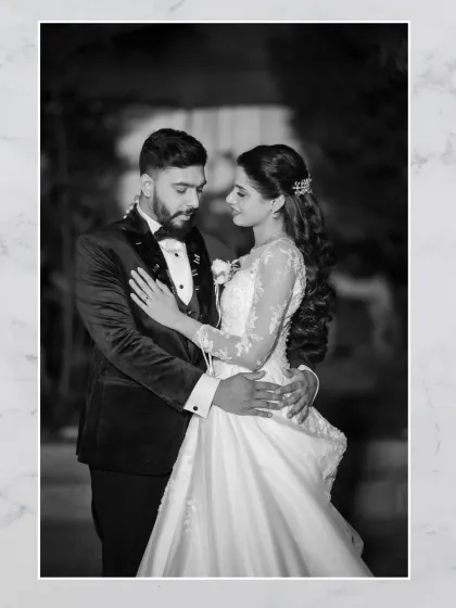 A timeless black and white portrait of the couple. This image has a classic, film-like quality that emphasizes their elegance and romance.