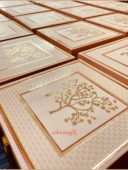 The lids of our custom wedding boxes, featuring a beautiful tree-of-life motif in gold foil. This level of detail makes our wedding stationery and gift boxes truly special.