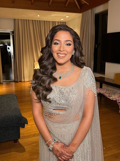 Grace in every strand, love in every curl. This client is glowing with her voluminous side-swept curls at a destination wedding in Goa.