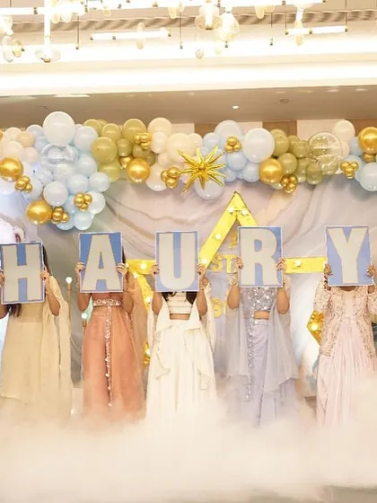 The big reveal of baby Shaurya's name. Family members hold up letters in front of a cloud of dry ice, making for a dramatic and memorable naming ceremony moment.