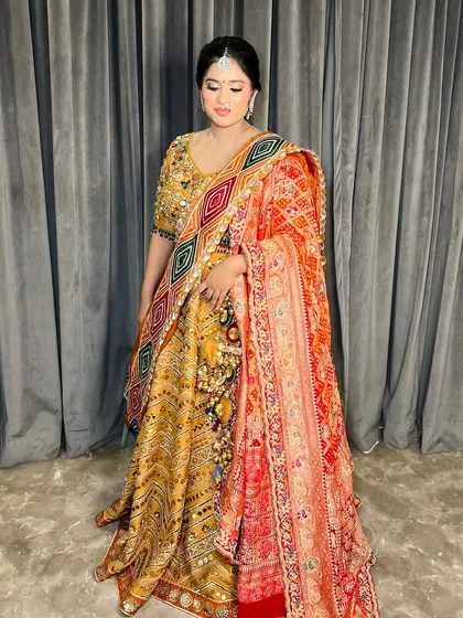 A full-length shot of the bride in her vibrant, multi-coloured lehenga, showing how the hair, makeup, and outfit come together.