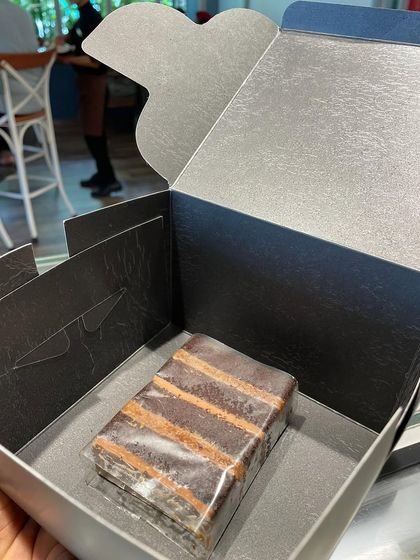 Our cake slices come in a beautiful box, making them perfect for gifting or just for a personal treat. Here's a single slice, ready to be enjoyed.