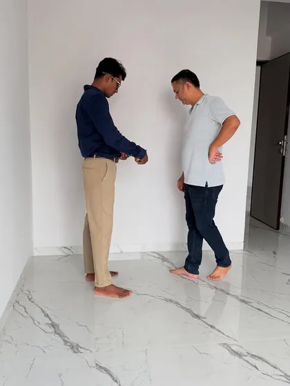 Taking measurements and discussing the initial plans with the client on-site.