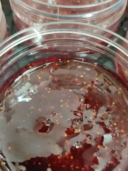 A close-up of the texture of our Strawberry Preserve. You can see the real fruit and seeds, a sign of a truly homemade and natural product.