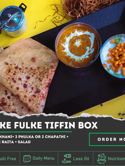 For those who want a simple, light, and nutritious meal, our 'Hulke Fulke' Tiffin Box is the answer. Enjoy creamy Dal Makhani with soft phulkas, cool Boondi Raita, and a side of salad.