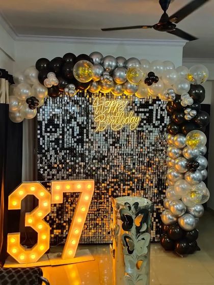 A black and silver sequin backdrop in a home setting, showing how I can transform any space for a special birthday.
