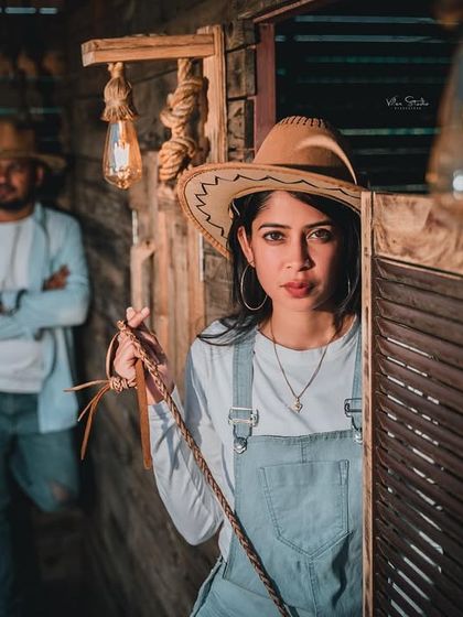 Another shot from the Western theme, this one with a more mysterious and dramatic feel. The bride-to-be peeks out from behind a door, adding intrigue to the photo.
