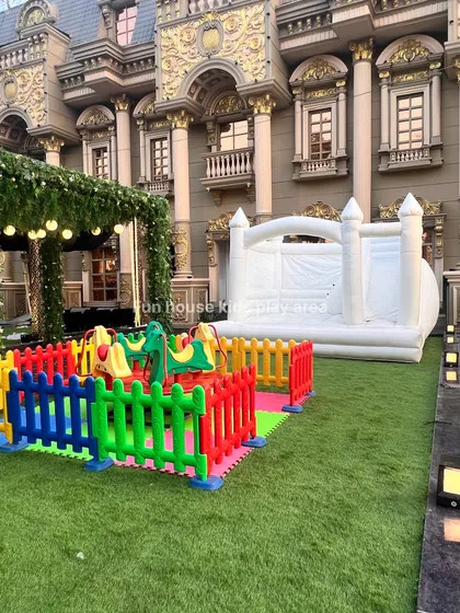 A perfect party combination featuring our colorful animal merry-go-round and a large white bouncy castle. This setup is ideal for outdoor events, offering both spinning and jumping fun for kids.