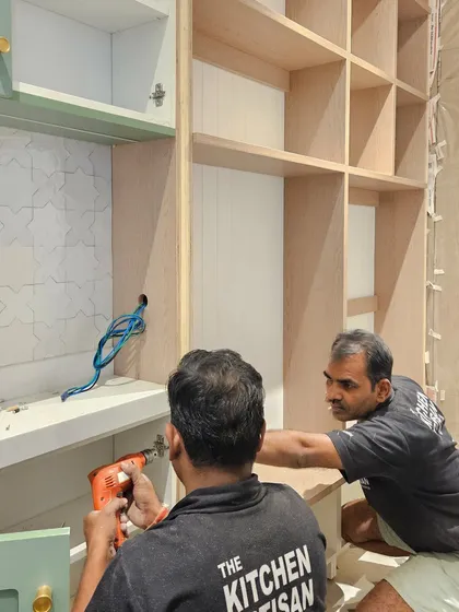 Here, my team is carefully installing a large open-shelf unit. This behind-the-scenes shot shows the precision and teamwork required to execute our custom designs perfectly.