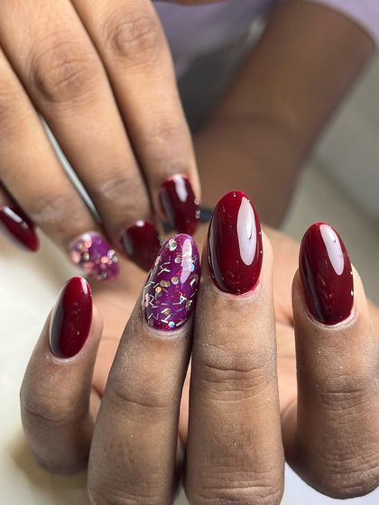 This angle shows the glossy finish and almond shape of the nails. The glitter accent nail adds texture and catches the light beautifully.