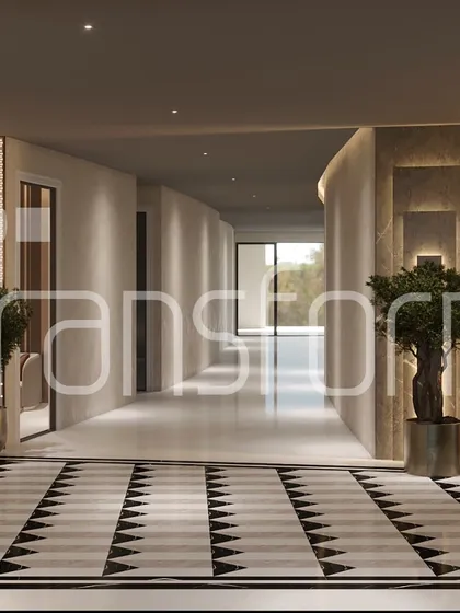 A view down a corridor that demonstrates the power of intentional design. The geometric marble inlay leads the eye forward, creating a sense of movement and flow, while the subtle wall textures and lighting guide the transition between spaces.