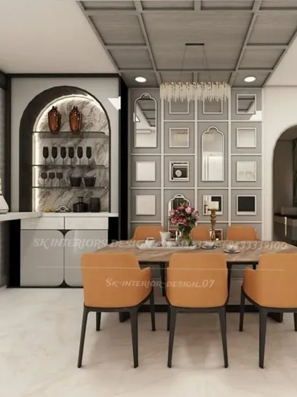 A sophisticated dining space featuring an arched bar and crockery unit. The mirrored gallery wall opposite the dining table creates an illusion of depth, making the area feel larger and more grand.