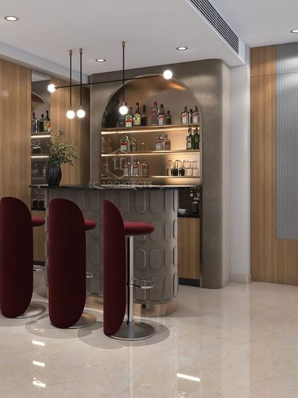 A close-up of the bar area in a modern living room. The design features plush, curved bar stools in a rich burgundy, a textured bar front, and an arched, backlit shelving unit.