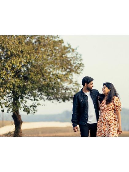 The couple takes a stroll through the countryside, a simple and beautiful moment from their pre-wedding story.
