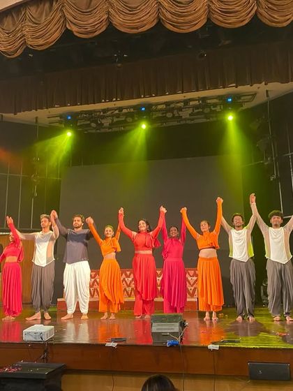 Behind the scenes from our contemporary dance production "Ghat," with the cast taking a final bow on stage.