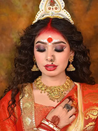 A powerful concept shoot inspired by Maa Durga, with the model in a traditional red and gold saree. The closed eyes convey a sense of divine peace.