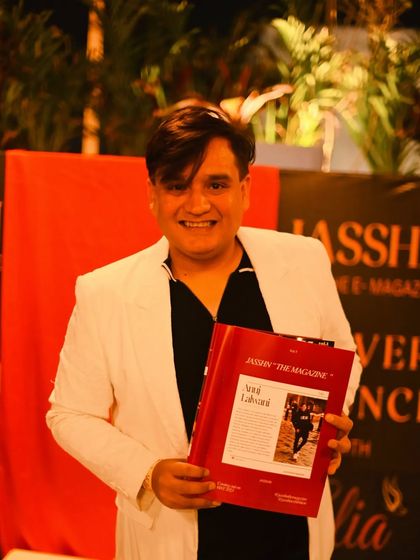 Holding the Jasshn magazine with my feature inside. I'm grateful for the opportunity to share my story and passion for fashion.