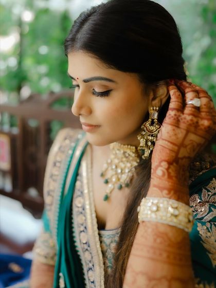 A serene moment during the mehendi ceremony. The makeup is kept soft and elegant, perfect for capturing these intimate memories.