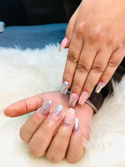 A full view of the elegant pink and silver glitter extensions.