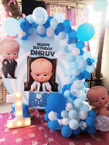 A Boss Baby themed ring decoration for a first birthday. This setup uses a light blue and white color scheme and includes a large light-up number "1".