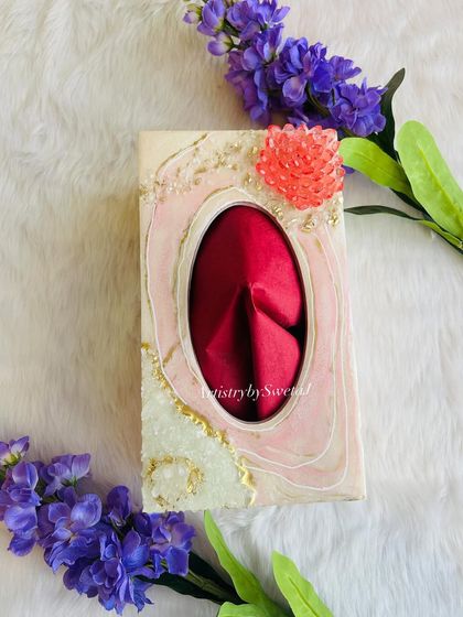 A top-down view of the geode napkin holder, showing the beautiful resin flow and the sparkling crystal flower accent.