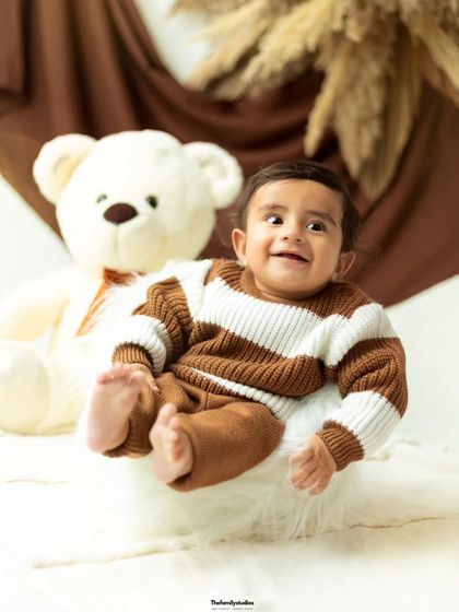 A big, gummy smile from this little one makes for an unforgettable portrait from his milestone session.