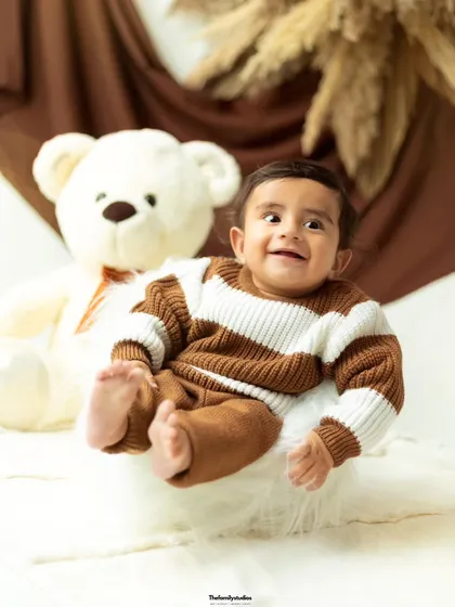 A big, gummy smile from this little one makes for an unforgettable portrait from his milestone session.