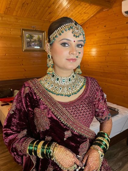 Showcasing the royal elegance of this bride's reception look, with soft glam makeup that complements her rich velvet lehenga.